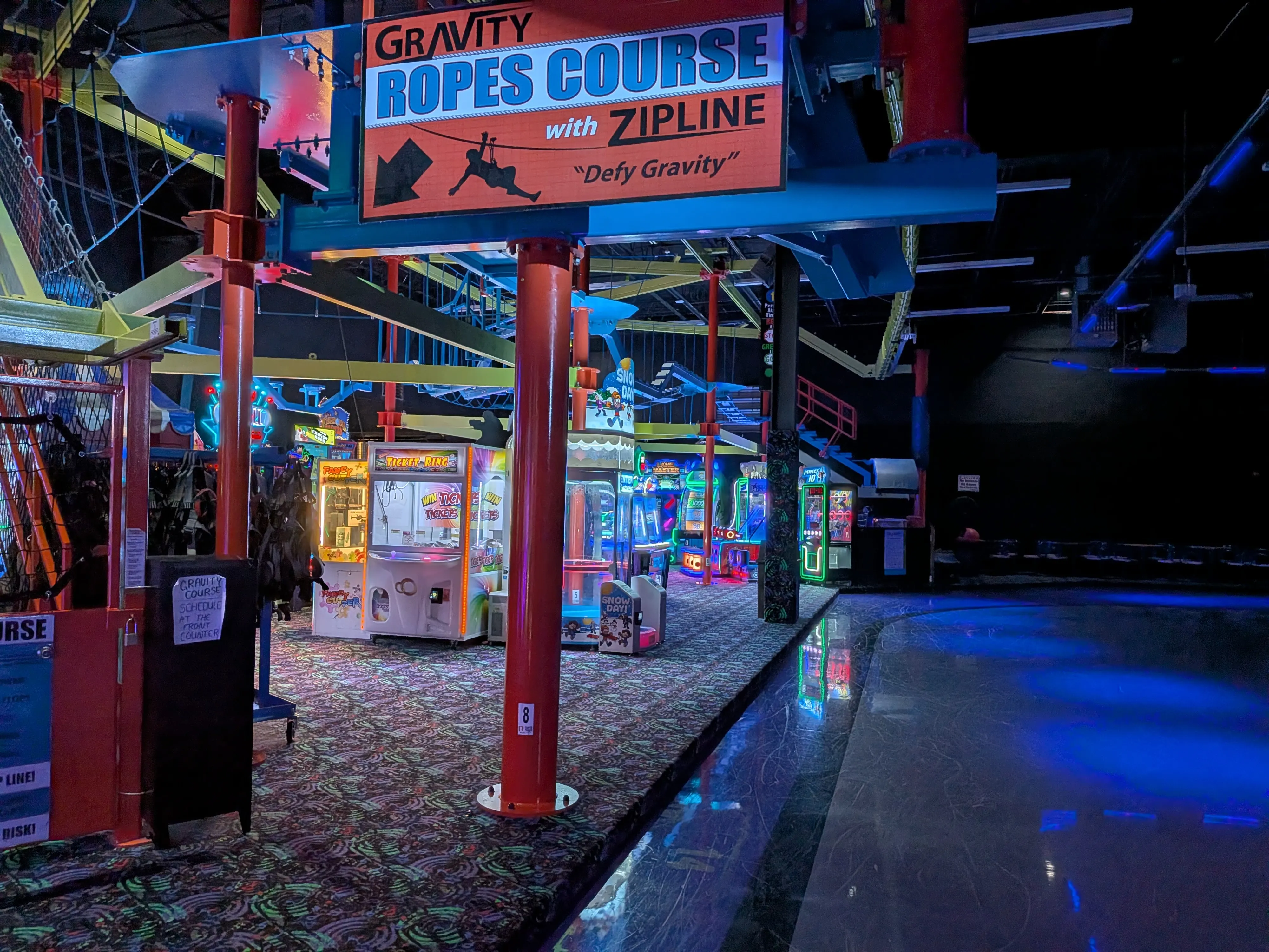Child navigating the Gravity Course suspended over the arcade